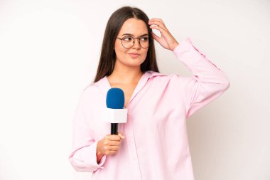 hispanic pretty woma smiling and looking friendly, showing number four. journalist with a microphone