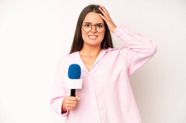 hispanic pretty woma shouting aggressively, looking very angry. journalist with a microphone