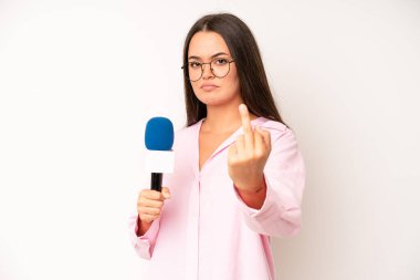 hispanic pretty woma feeling happy and facing a challenge or celebrating. journalist with a microphone