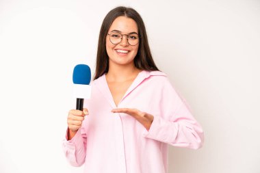 hispanic pretty woma feeling extremely shocked and surprised. journalist with a microphone
