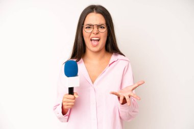 hispanic pretty woma pointing at camera choosing you. journalist with a microphone