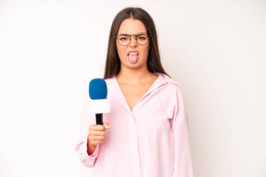 hispanic pretty woma with cheerful and rebellious attitude, joking and sticking tongue out. journalist with a microphone