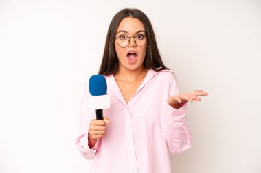 hispanic pretty woma feeling angry, annoyed, rebellious and aggressive. journalist with a microphone