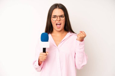 hispanic pretty woma shrugging, feeling confused and uncertain. journalist with a microphone