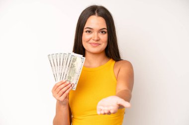 hispanic pretty woma amazed, shocked and astonished with an unbelievable surprise. dollar banknotes concept