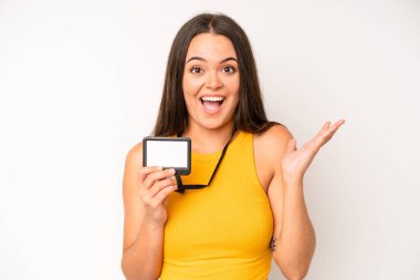 hispanic pretty woma feeling shocked and scared. vip pass id card concept