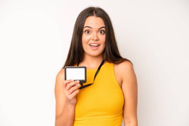 hispanic pretty woma feeling happy and pointing to self with an excited. vip pass id card concept