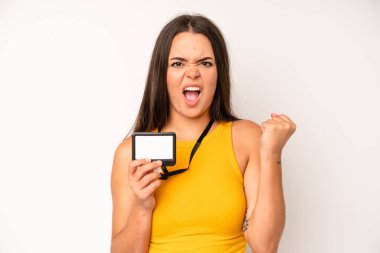 hispanic pretty woma shrugging, feeling confused and uncertain. vip pass id card concept