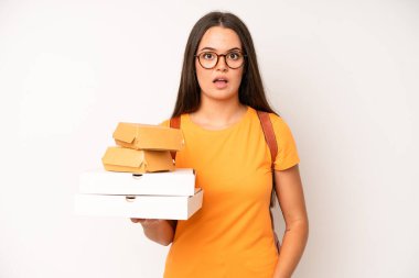 hispanic pretty woma looking surprised, realizing a new thought, idea or concept. delivery take away concept