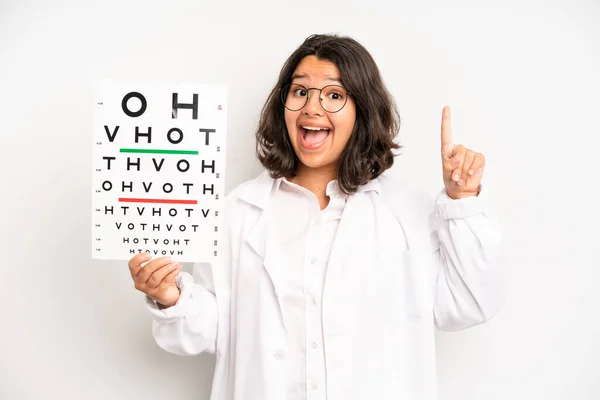 Hispanic Pretty Girl Smiling Happily Daydreaming Doubting Optical Vision Test — Stockfoto