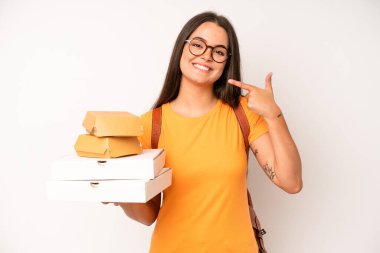 hispanic pretty woma smiling happily with a hand on hip and confident. delivery take away concept