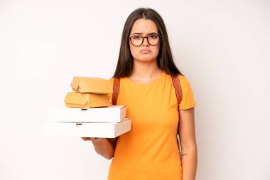 hispanic pretty woma smiling and looking happy, gesturing victory or peace. delivery take away concept