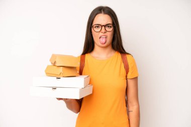 hispanic pretty woma with cheerful and rebellious attitude, joking and sticking tongue out. delivery take away concept
