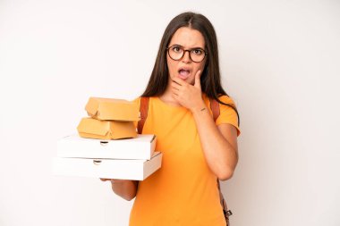 hispanic pretty woma smiling happily, waving hand, welcoming and greeting you. delivery take away concept