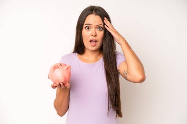 hispanic pretty woma looking angry, annoyed and frustrated. piggy bank savings concept
