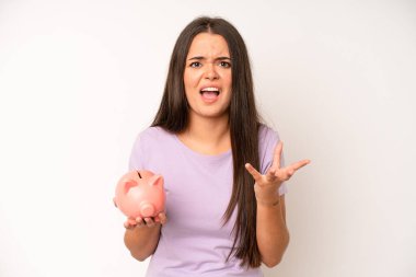 hispanic pretty woma smiling happily with friendly and  offering and showing a concept. piggy bank savings concept