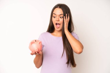 hispanic pretty woma feeling stressed, anxious, tired and frustrated. piggy bank savings concept