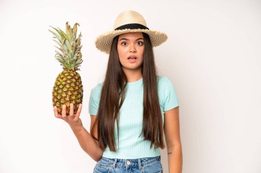 hispanic pretty woma looking surprised, realizing a new thought, idea or concept. pineapple and summer concept