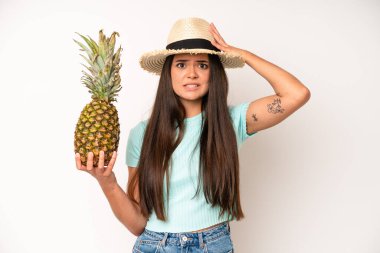 hispanic pretty woma shouting aggressively, looking very angry. pineapple and summer concept