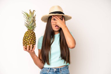 hispanic pretty woma looking unhappy and stressed, suicide gesture making gun sign. pineapple and summer concept
