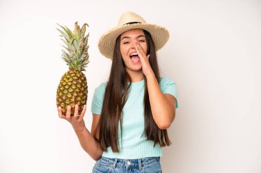 hispanic pretty woma looking puzzled and confused. pineapple and summer concept