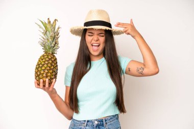 hispanic pretty woma feeling cross,showing thumbs down. pineapple and summer concept