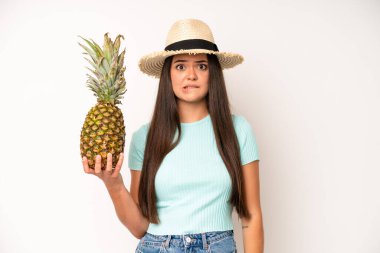 hispanic pretty woma looking serious showing open palm making stop gesture. pineapple and summer concept