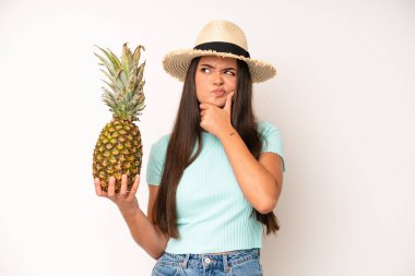 hispanic pretty woma smiling proudly and confidently making number one. pineapple and summer concept