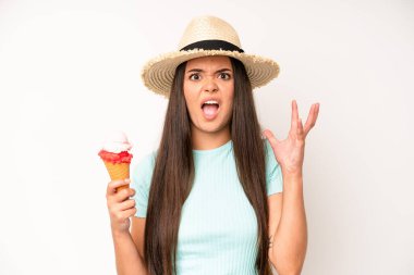 hispanic pretty woma feeling happy,giving a big shout out with hands next to mouth. ice cream and summer concept
