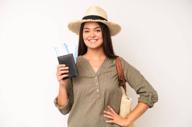 hispanic pretty woma smiling and looking friendly, showing number two. travel and summer concept