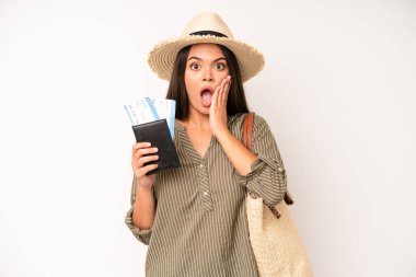 hispanic pretty woma feeling shocked,laughing and celebrating success. travel and summer concept