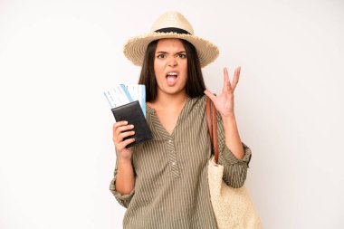 hispanic pretty woma feeling happy,giving a big shout out with hands next to mouth. travel and summer concept