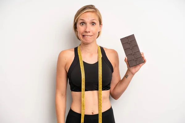 Pretty Caucasian Woman Looking Puzzled Confused Chocolate Fitness Concept — Stock Photo, Image