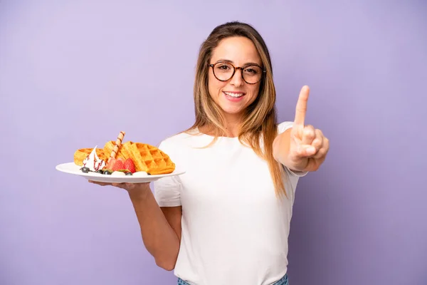 Pretty Caucasian Woman Smiling Looking Friendly Showing Number One Waffles —  Fotos de Stock