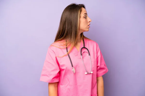 pretty caucasian woman on profile view thinking, imagining or daydreaming. medicine doctor concept