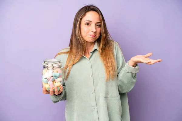 Pretty Caucasian Woman Feeling Puzzled Confused Doubting Candies Bottle Concept — Stockfoto