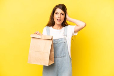 pretty caucasian woman feeling stressed, anxious or scared, with hands on head. take away concept