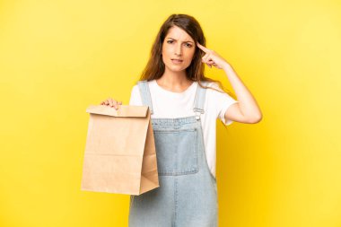 pretty caucasian woman feeling confused and puzzled, showing you are insane. take away concept