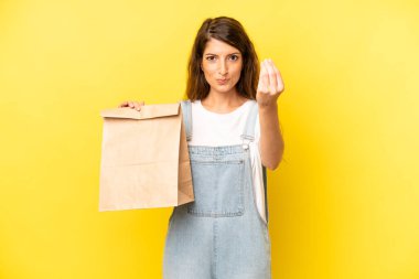 pretty caucasian woman making capice or money gesture, telling you to pay. take away concept