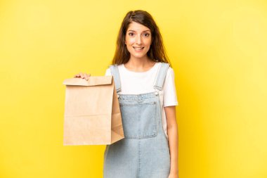 pretty caucasian woman looking happy and pleasantly surprised. take away concept
