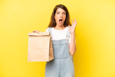 pretty caucasian woman screaming with hands up in the air. take away concept