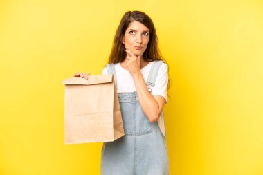 pretty caucasian woman thinking, feeling doubtful and confused. take away concept