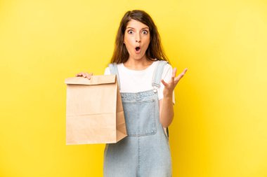 pretty caucasian woman feeling extremely shocked and surprised. take away concept
