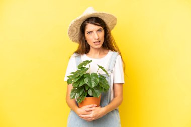 pretty caucasian woman feeling puzzled and confused. gardering concept