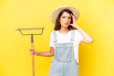 pretty caucasian woman looking happy, astonished and surprised. farmer concept