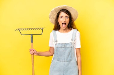 pretty caucasian woman looking very shocked or surprised. farmer concept