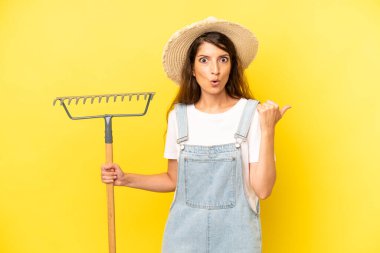 pretty caucasian woman looking astonished in disbelief. farmer concept