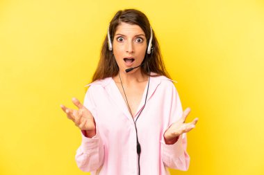 pretty caucasian woman feeling extremely shocked and surprised. telemarketing concept