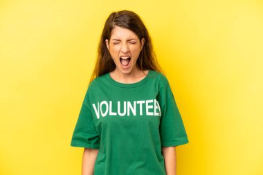 pretty caucasian woman shouting aggressively, looking very angry. enviromental volunteer concept