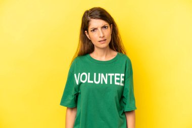 pretty caucasian woman feeling puzzled and confused. enviromental volunteer concept